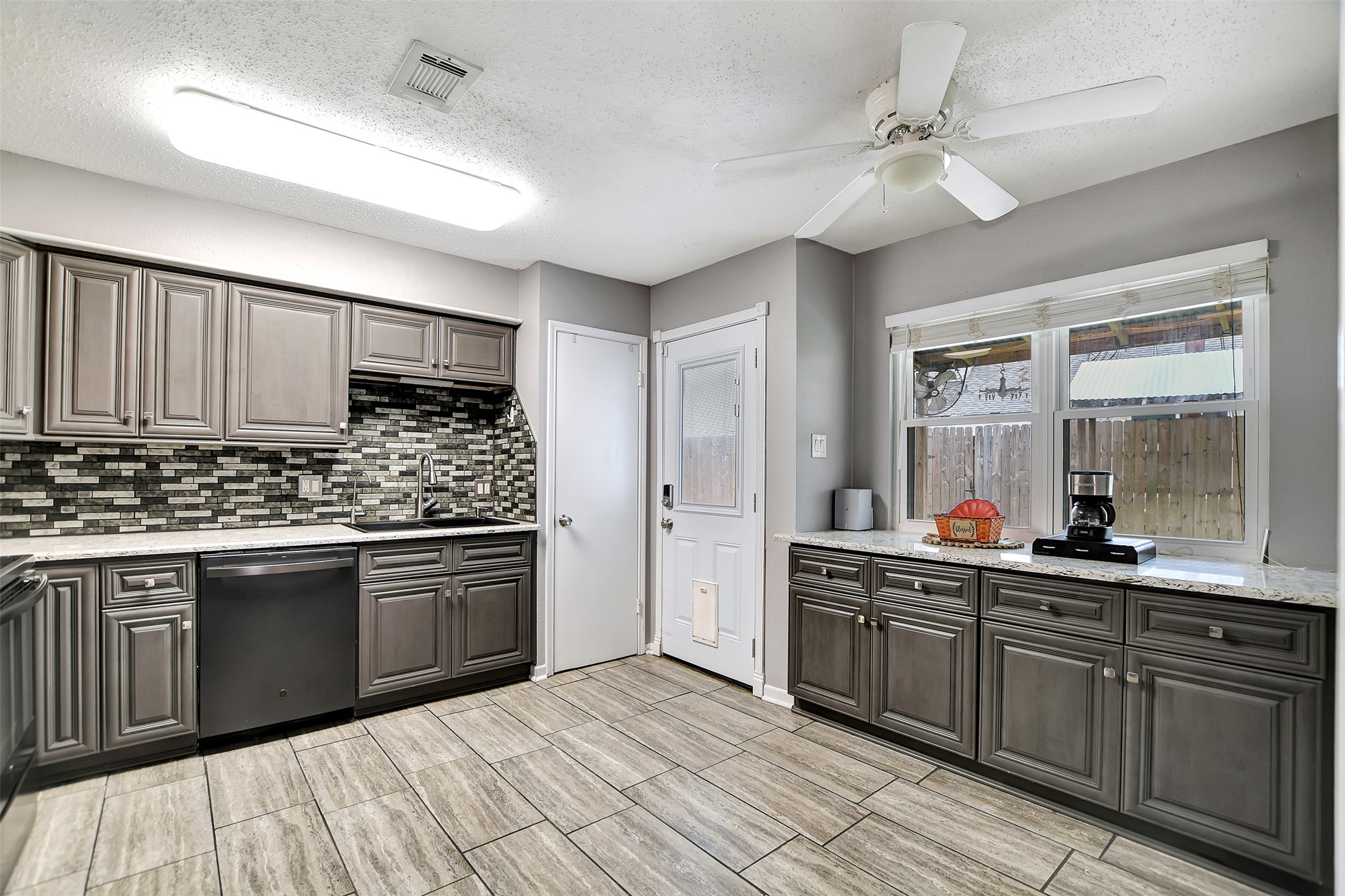 8 Arlington Street Conroe, TX 77301 - Photo 18 of 43 a kitchen with stainless steel appliances granite countertop a sink and cabinets