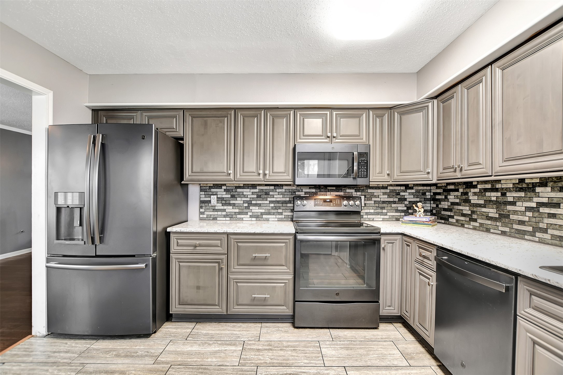 8 Arlington Street Conroe, TX 77301 - Photo 20 of 43 a kitchen with a stove sink and refrigerator
