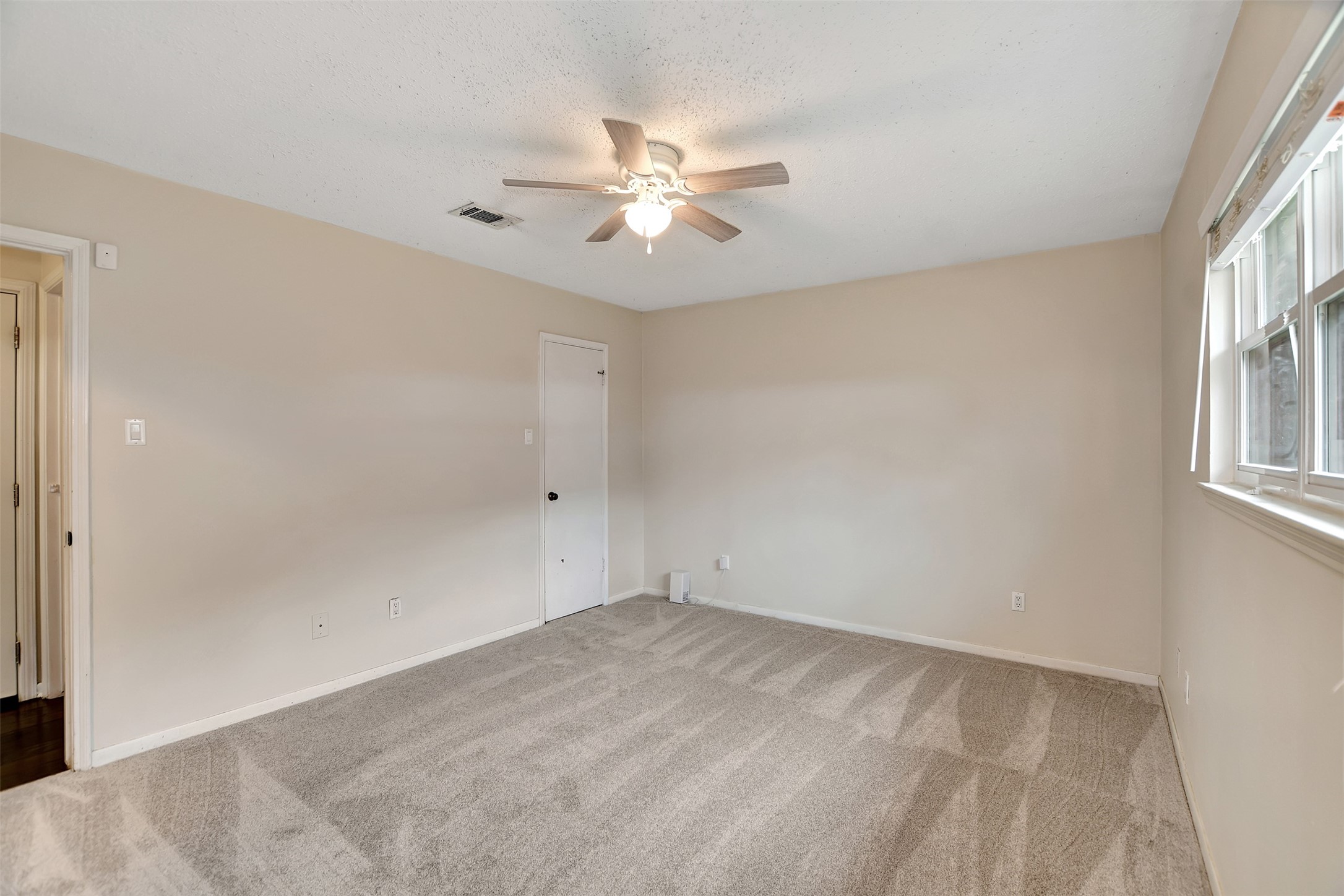 8 Arlington Street Conroe, TX 77301 - Photo 24 of 43 an empty room with windows and fan