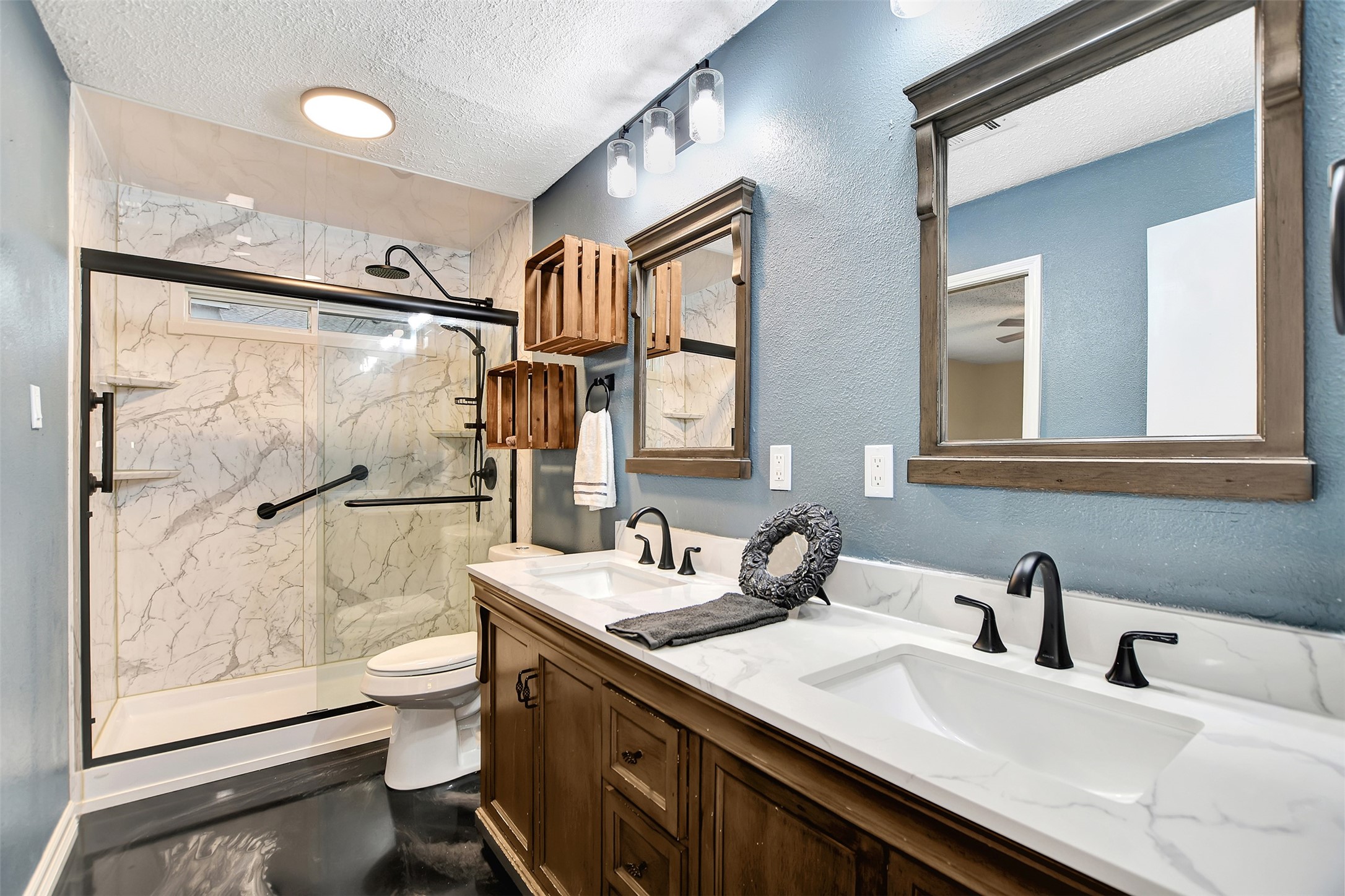 8 Arlington Street Conroe, TX 77301 - Photo 26 of 43 a bathroom with a double vanity sink toilet mirror and shower