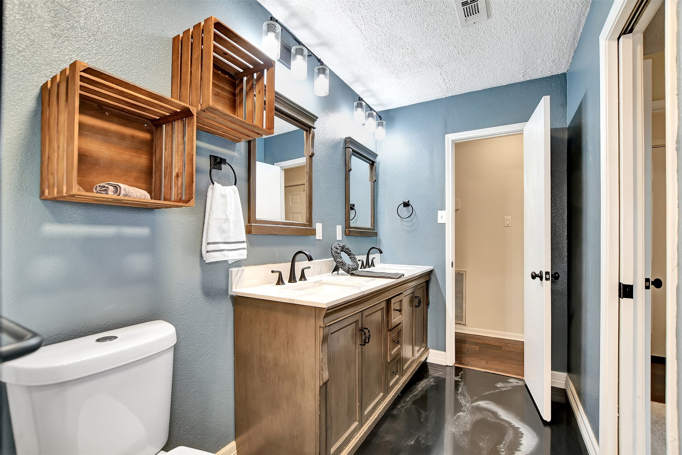 8 Arlington Street Conroe, TX 77301 - Photo 28 of 43 a bathroom with a toilet sink and mirror