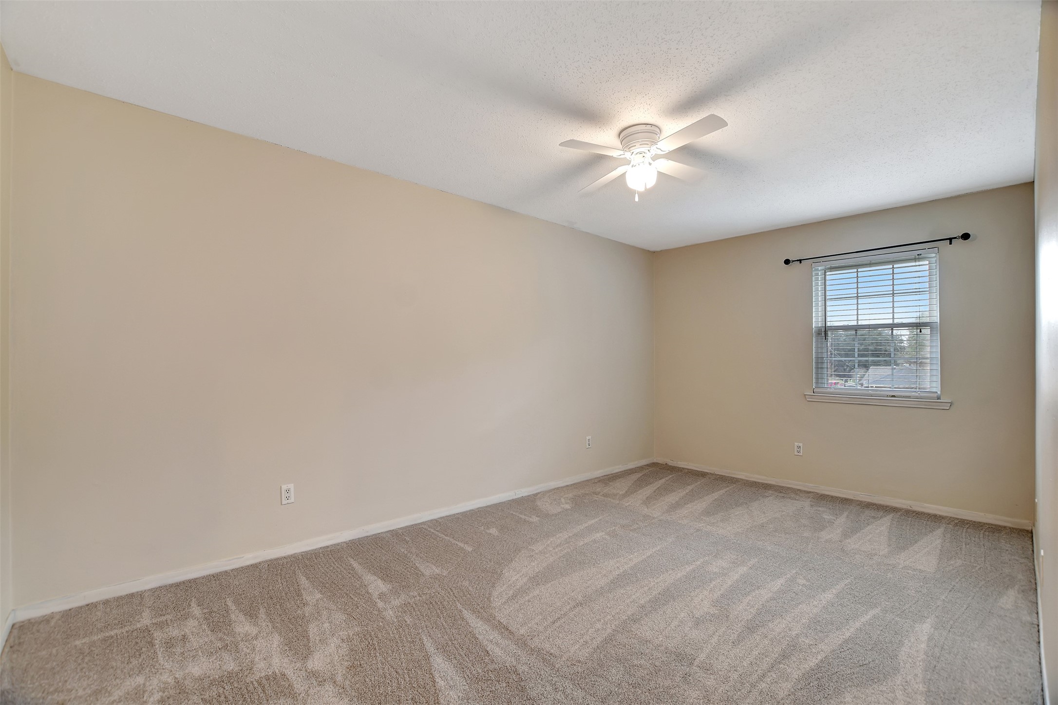 8 Arlington Street Conroe, TX 77301 - Photo 32 of 43 an empty room with a window and a fan