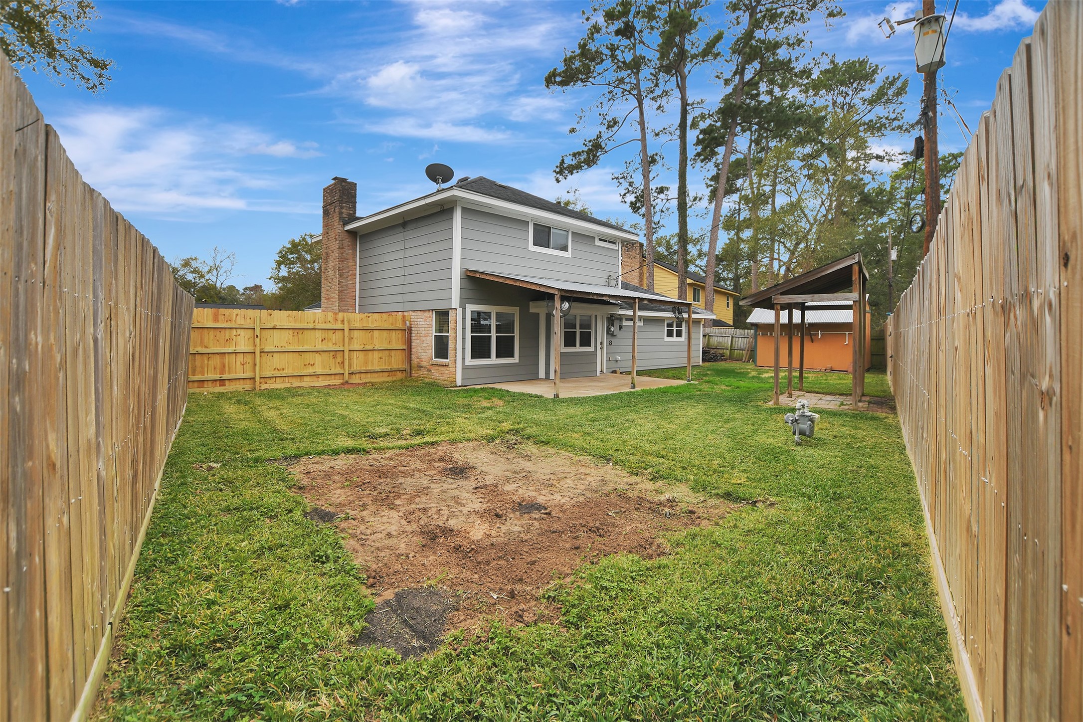 8 Arlington Street Conroe, TX 77301 - Photo 37 of 43 a view of a house with a yard