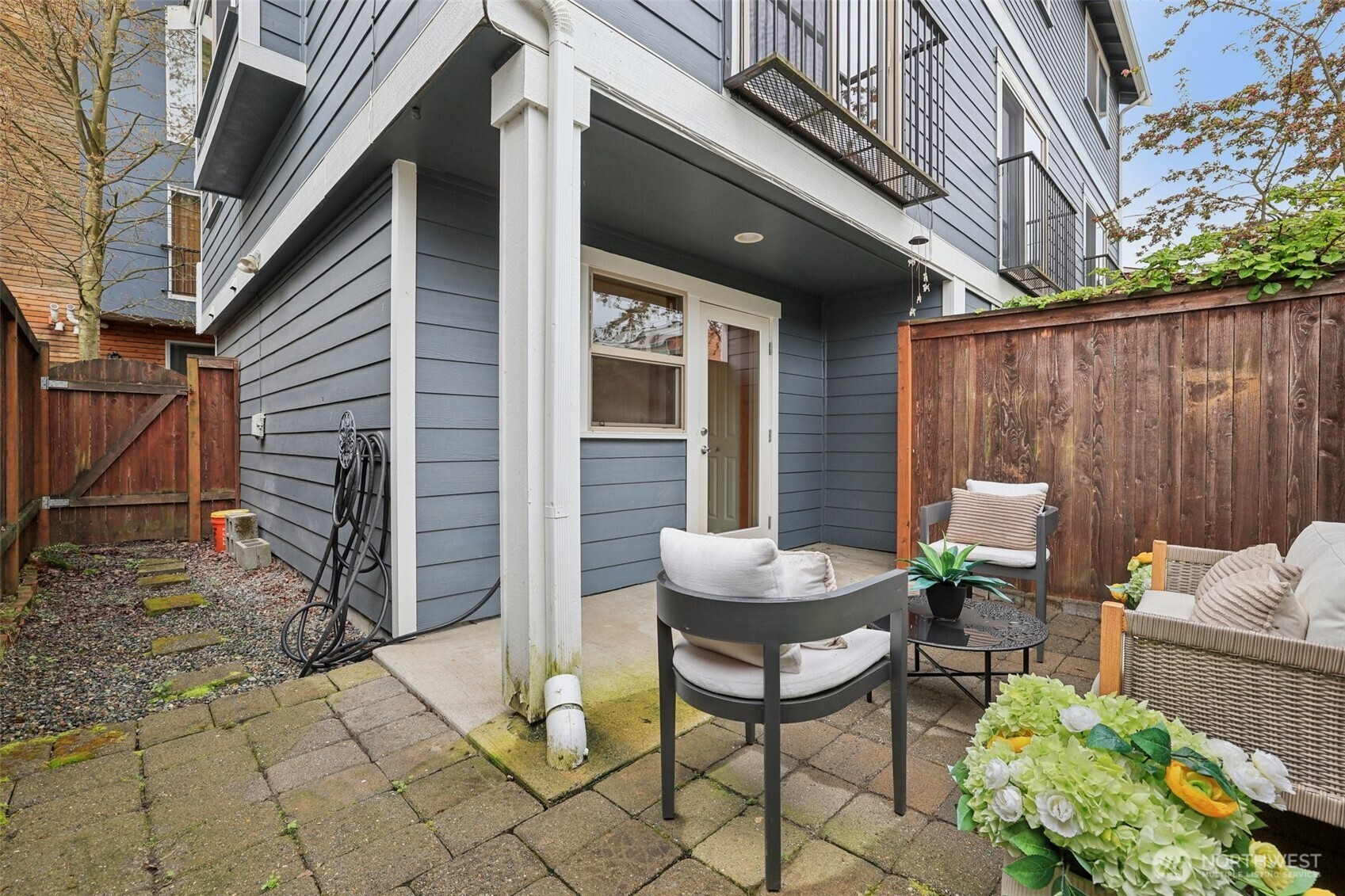 9047 17th Avenue Southwest, Unit A Seattle, WA 98106 - Photo 12 of 29 a view of a patio with table and chairs and potted plants