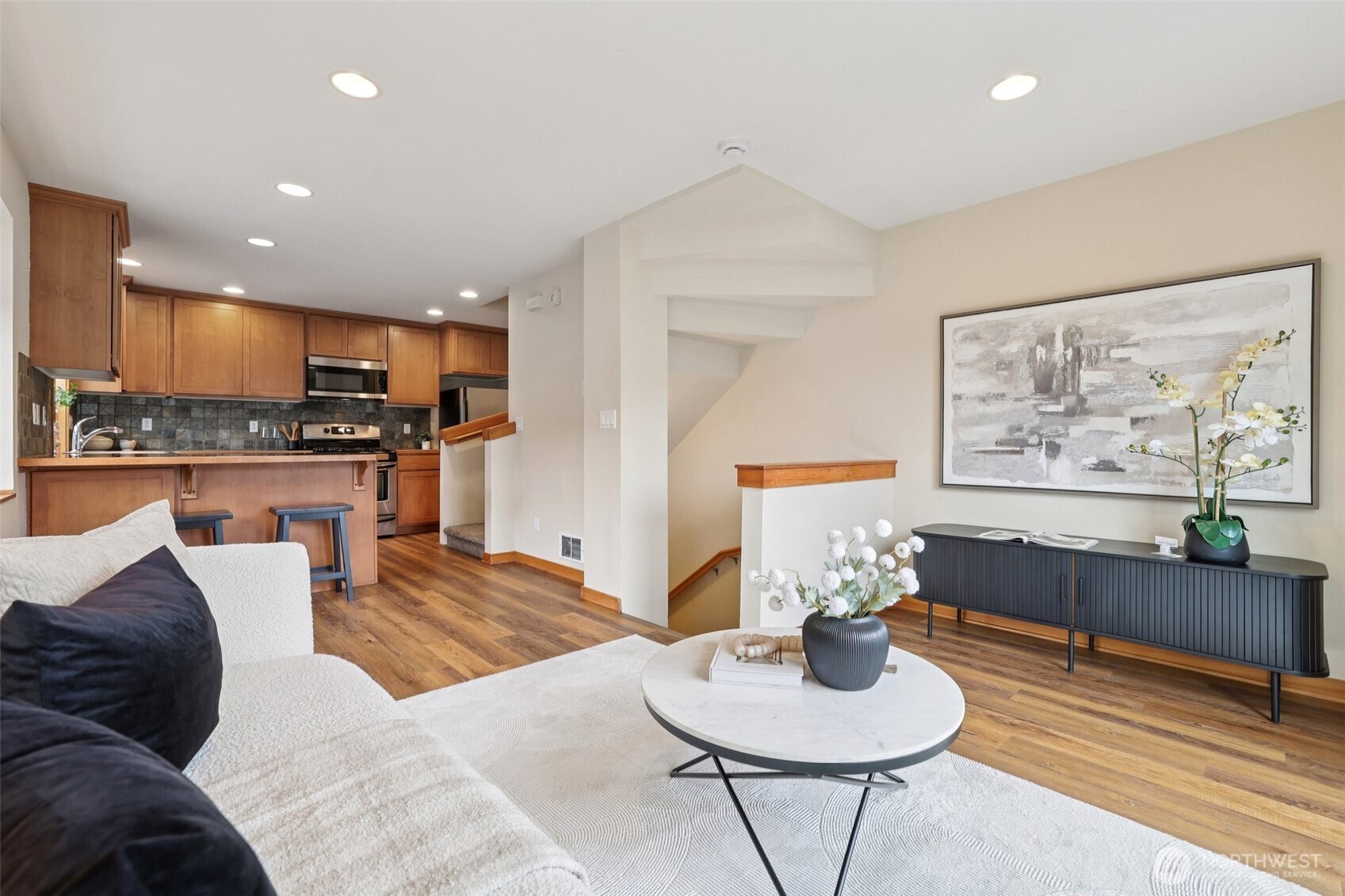 9047 17th Avenue Southwest, Unit A Seattle, WA 98106 - Photo 14 of 29 a living room with furniture kitchen view and a wooden floor