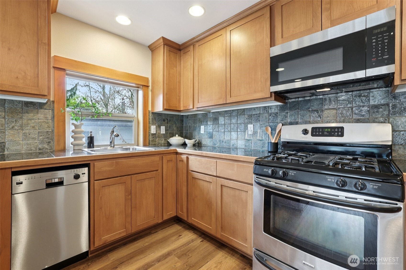 9047 17th Avenue Southwest, Unit A Seattle, WA 98106 - Photo 17 of 29 a kitchen with a stove a sink and a microwave