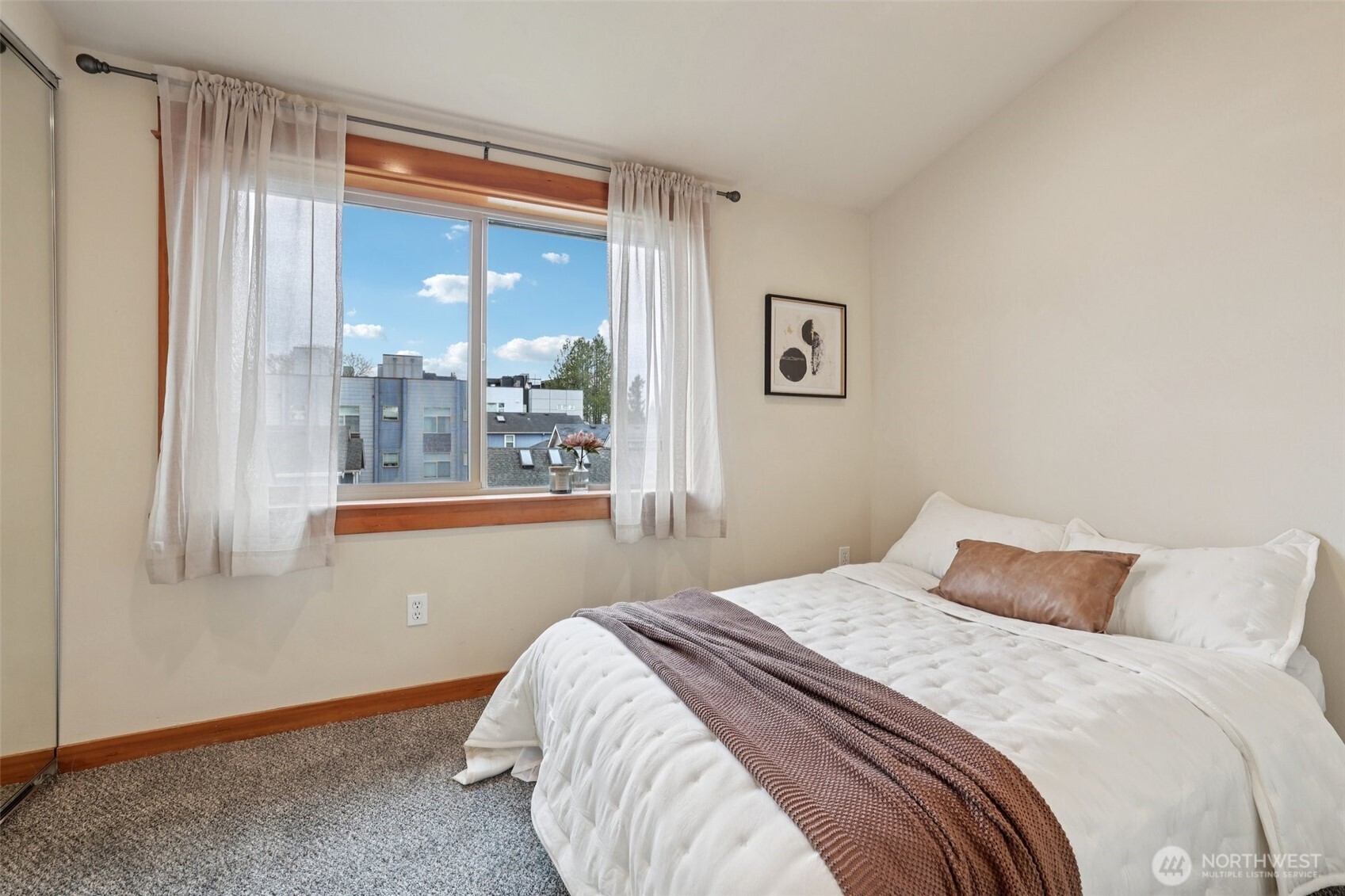 9047 17th Avenue Southwest, Unit A Seattle, WA 98106 - Photo 24 of 29 a bedroom with a bed and a large window