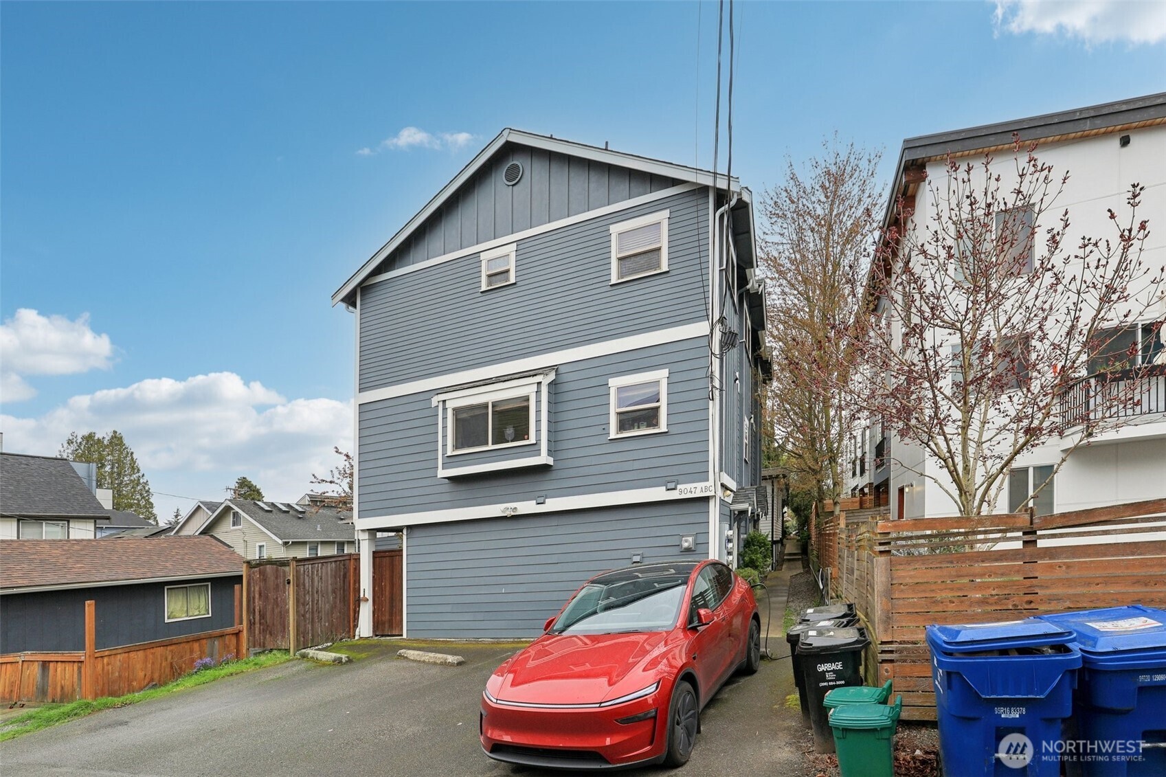 9047 17th Avenue Southwest, Unit A Seattle, WA 98106 - Photo 28 of 29 a front view of a house with a yard