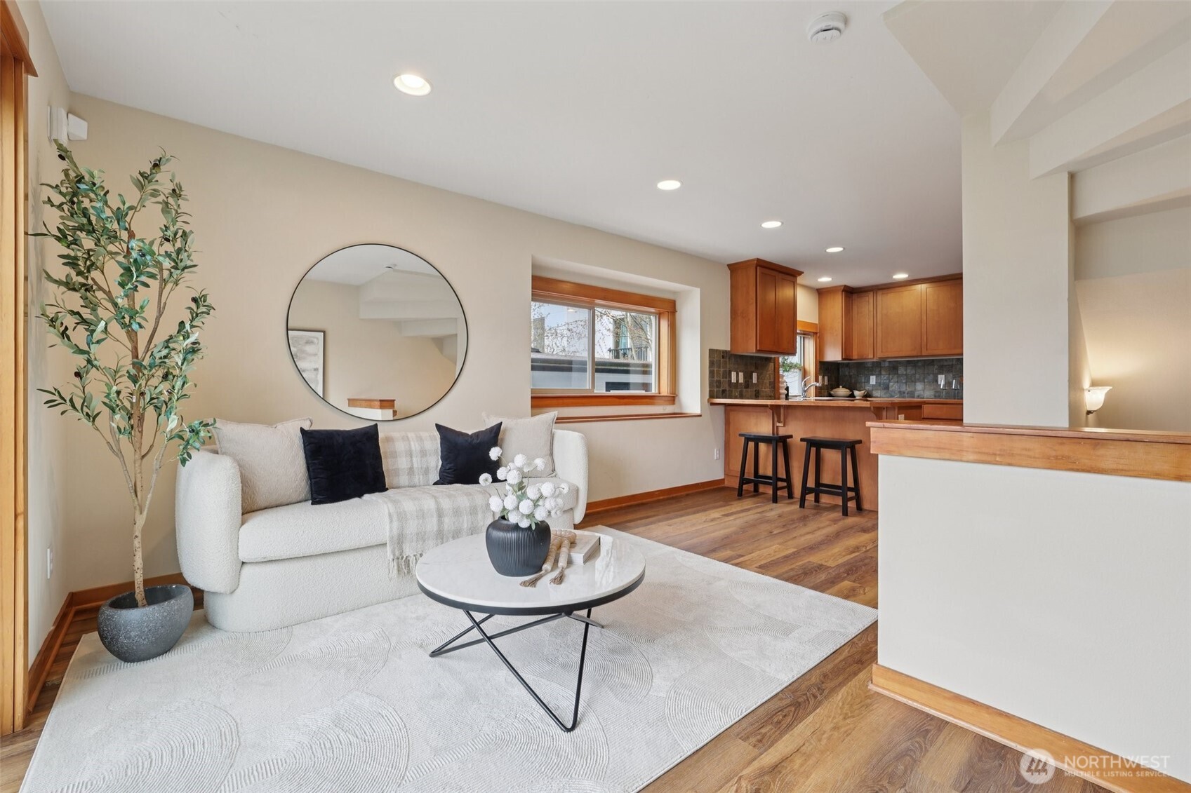9047 17th Avenue Southwest, Unit A Seattle, WA 98106 - Photo 3 of 29 a living room with stainless steel appliances kitchen island a table and kitchen view