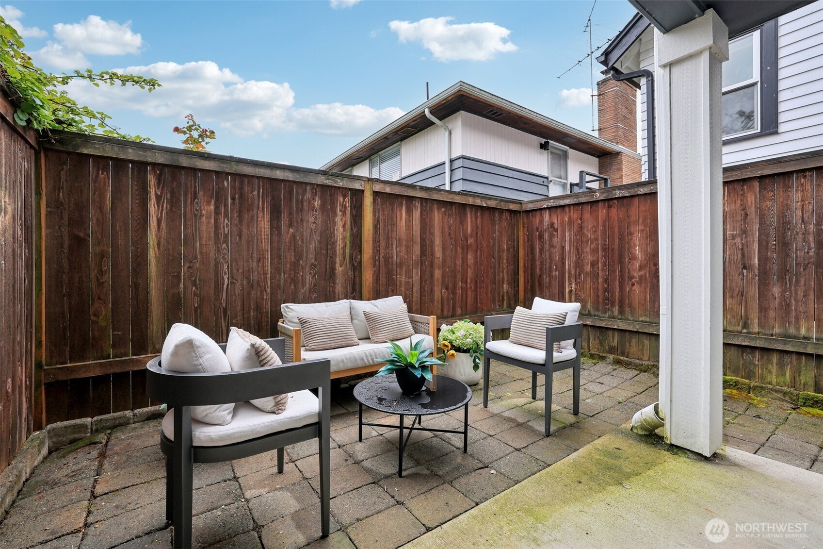 9047 17th Avenue Southwest, Unit A Seattle, WA 98106 - Photo 4 of 29 a view of a chairs and table in the back yard of the house
