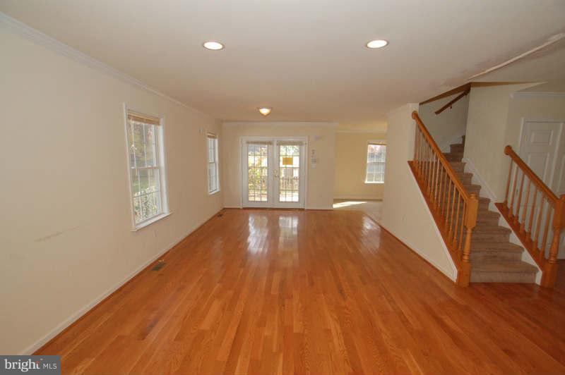 3641 Clifmar Road Baltimore, MD 21244 - Photo 2 of 27 a view of an empty room with wooden floor and fan
