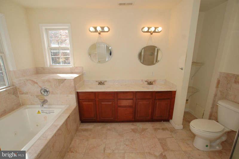 3641 Clifmar Road Baltimore, MD 21244 - Photo 15 of 27 a bathroom with a sink mirror and toilet