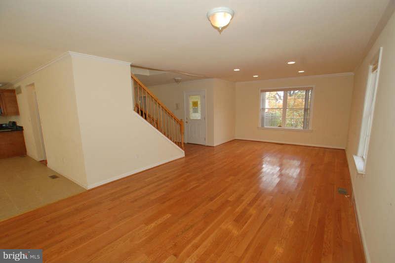 3641 Clifmar Road Baltimore, MD 21244 - Photo 3 of 27 a view of empty room with wooden floor and fan