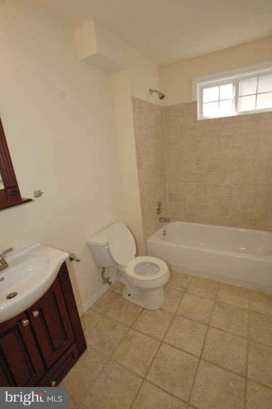 3641 Clifmar Road Baltimore, MD 21244 - Photo 8 of 27 a bathroom with a sink a toilet and shower
