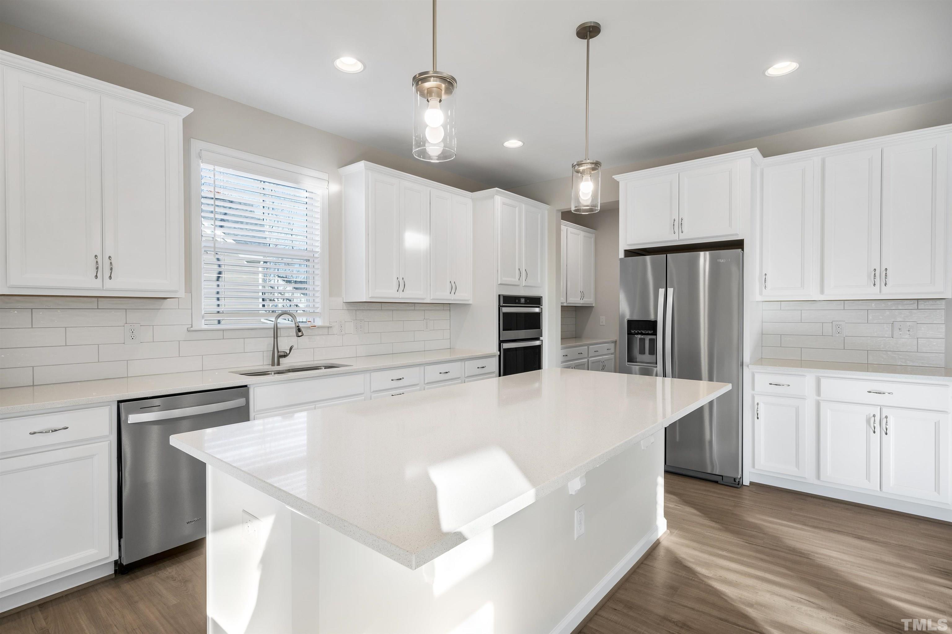 177 Karlov Road Garner, NC 27529 - Photo 13 of 39 a large kitchen with stainless steel appliances a large center island attached withe living room