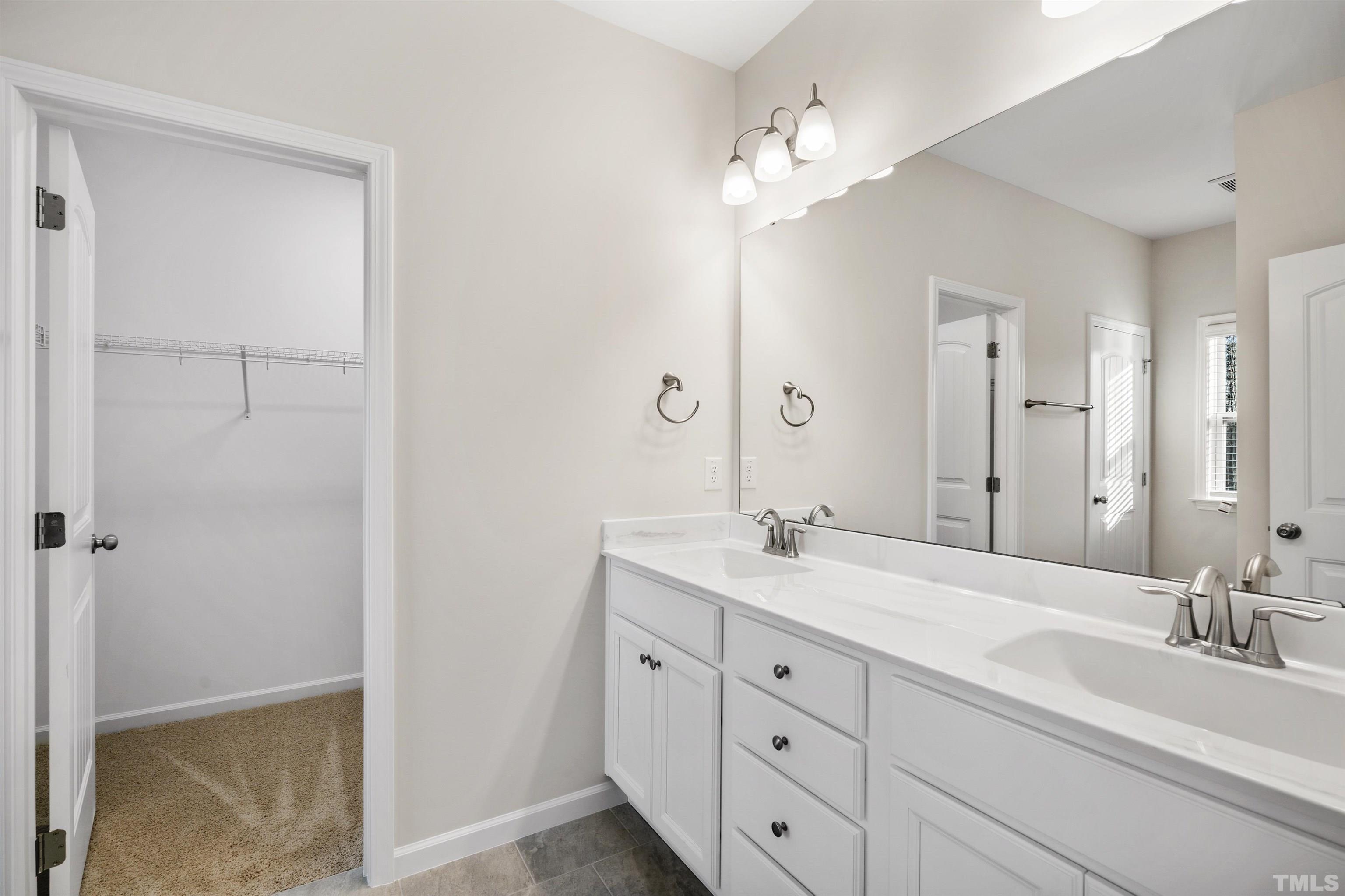 177 Karlov Road Garner, NC 27529 - Photo 21 of 39 a bathroom with a granite countertop sink double and mirror