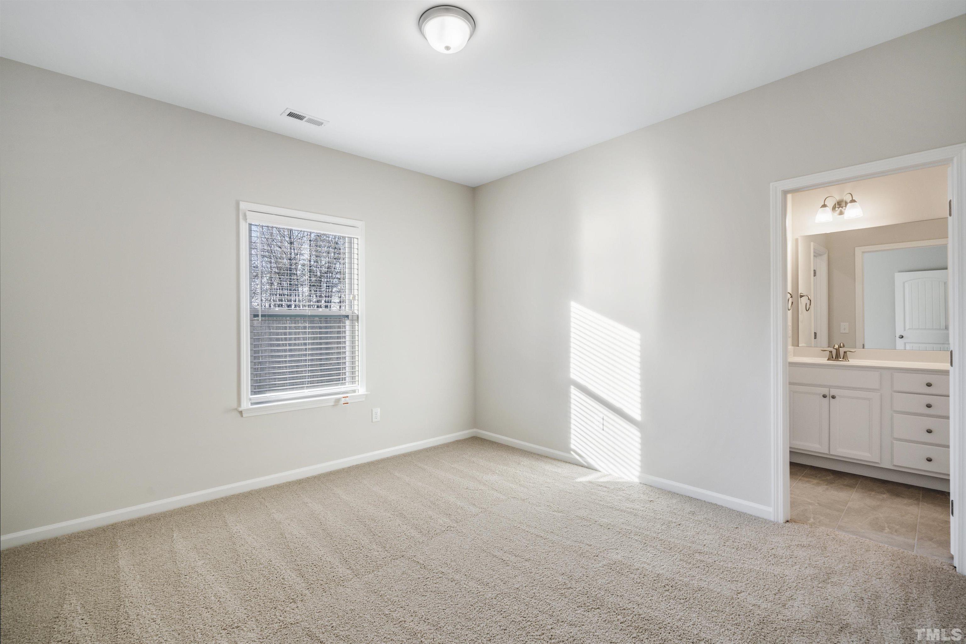 177 Karlov Road Garner, NC 27529 - Photo 22 of 39 an empty room with windows and cabinet