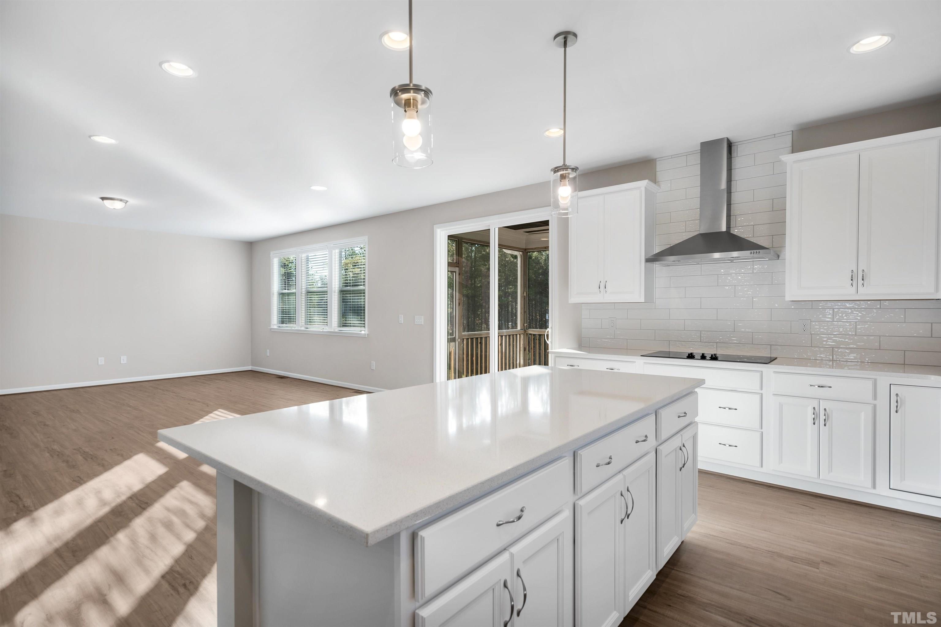 177 Karlov Road Garner, NC 27529 - Photo 23 of 39 a kitchen with granite countertop white cabinets and white appliances