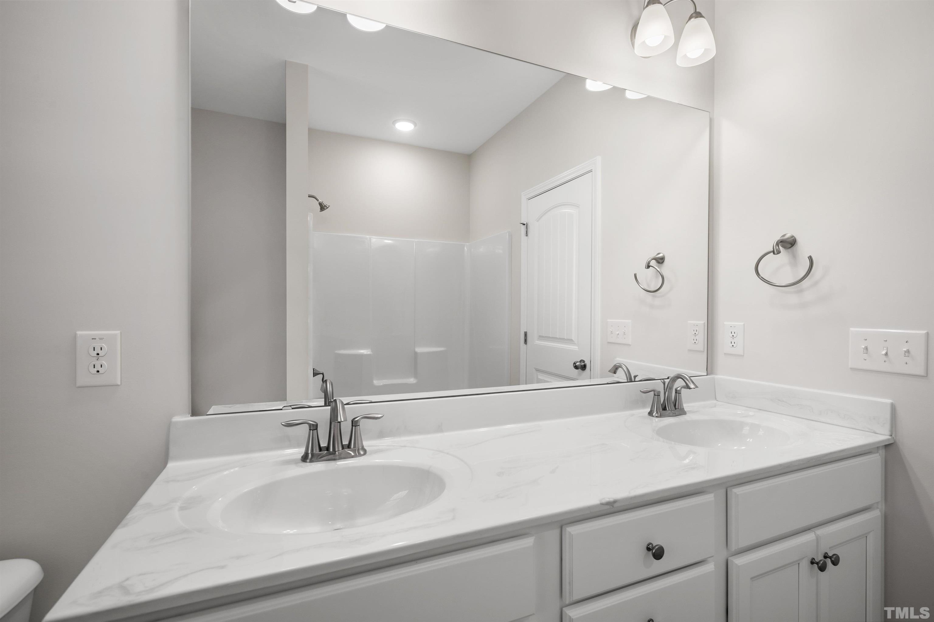 177 Karlov Road Garner, NC 27529 - Photo 29 of 39 a bathroom with a sink and a mirror