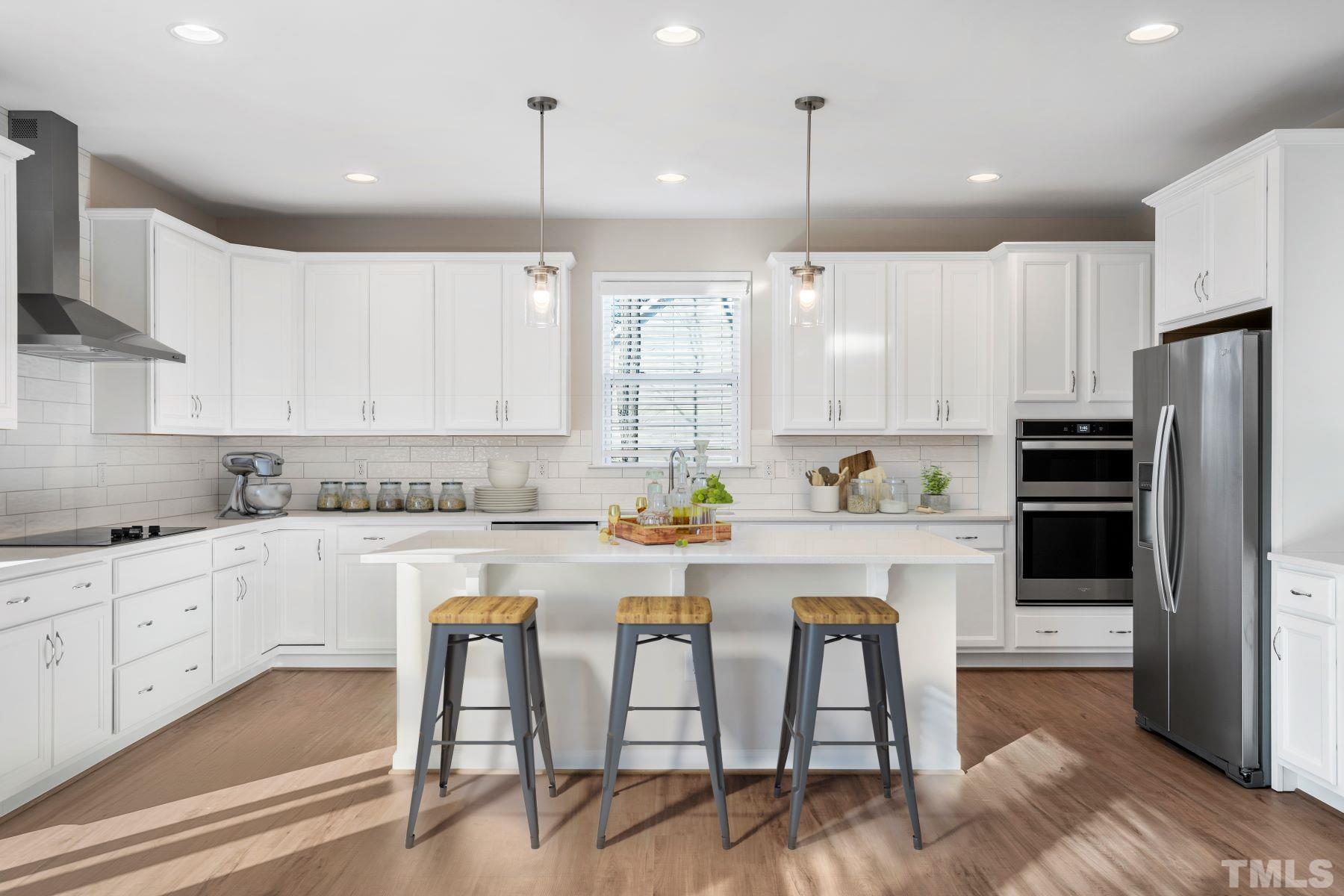 177 Karlov Road Garner, NC 27529 - Photo 3 of 39 a kitchen with white cabinets and stainless steel appliances