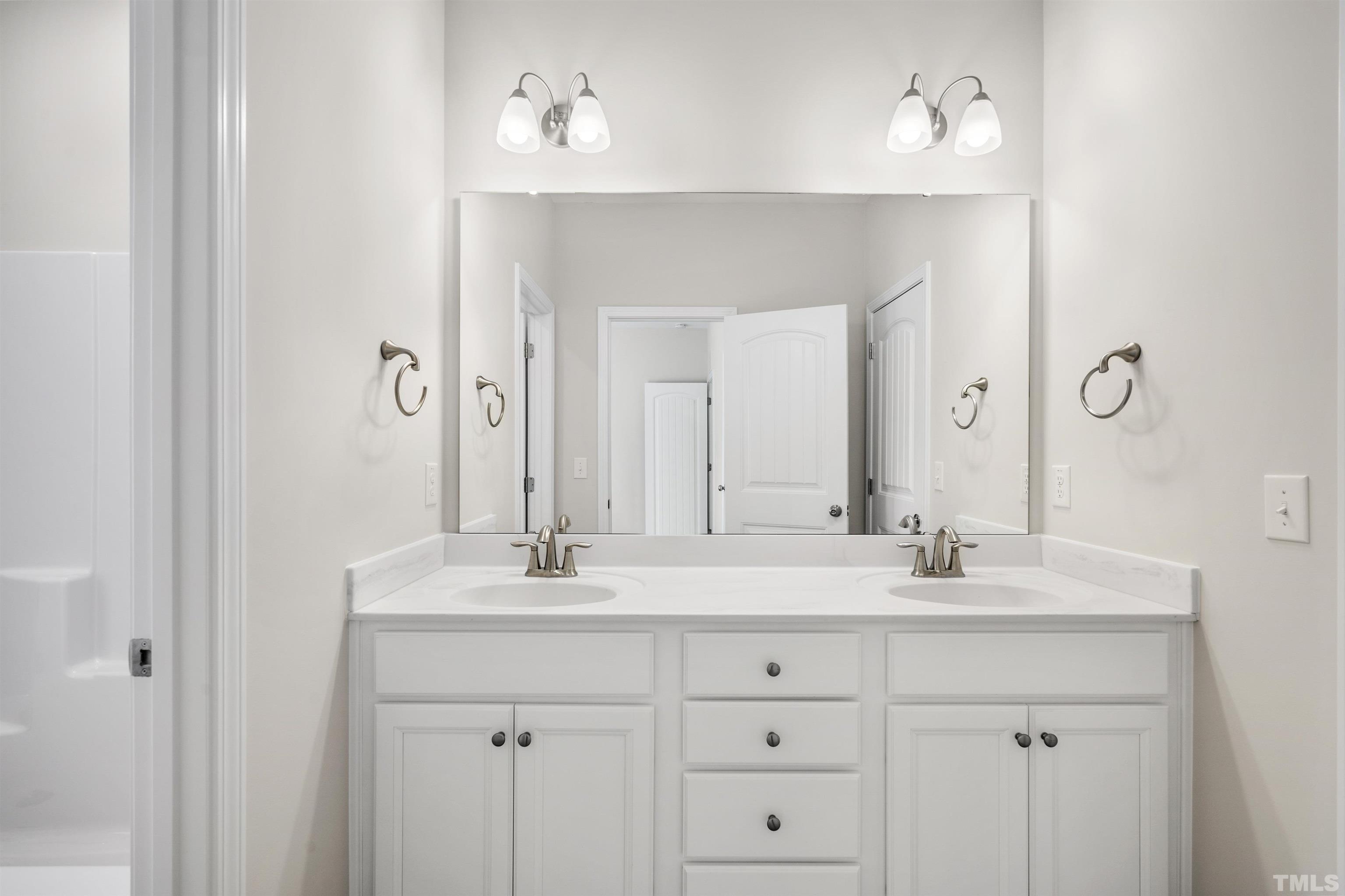 177 Karlov Road Garner, NC 27529 - Photo 31 of 39 a bathroom with a sink vanity and a mirror