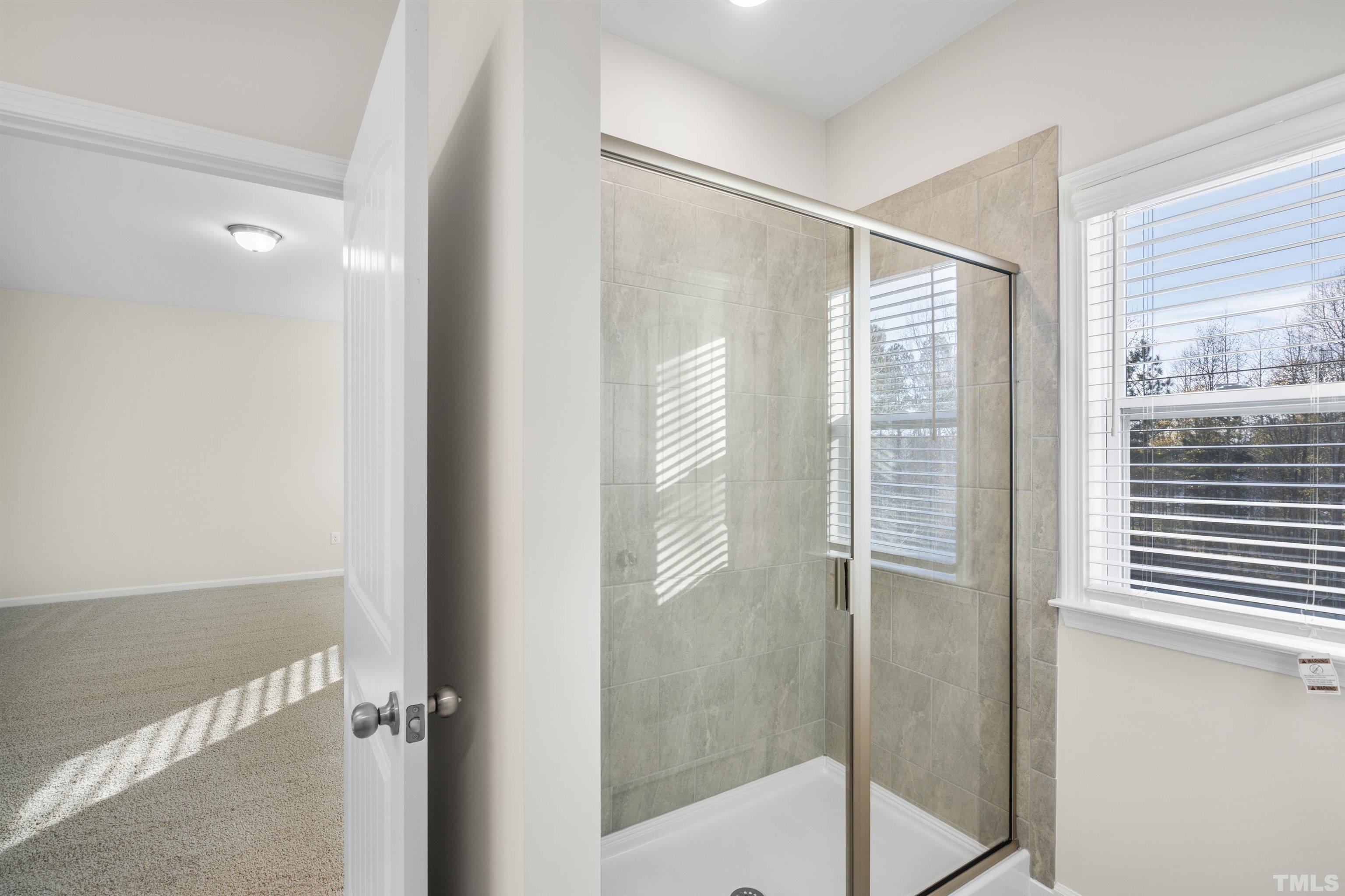 177 Karlov Road Garner, NC 27529 - Photo 36 of 39 a bathroom with a glass shower door