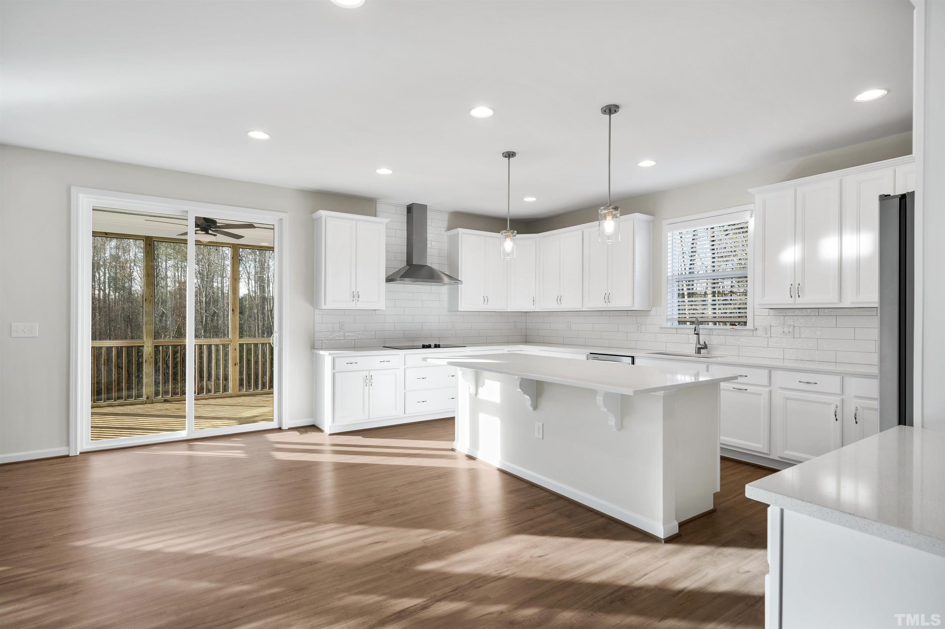 177 Karlov Road Garner, NC 27529 - Photo 37 of 39 a large kitchen with kitchen island a sink stainless steel appliances and cabinets