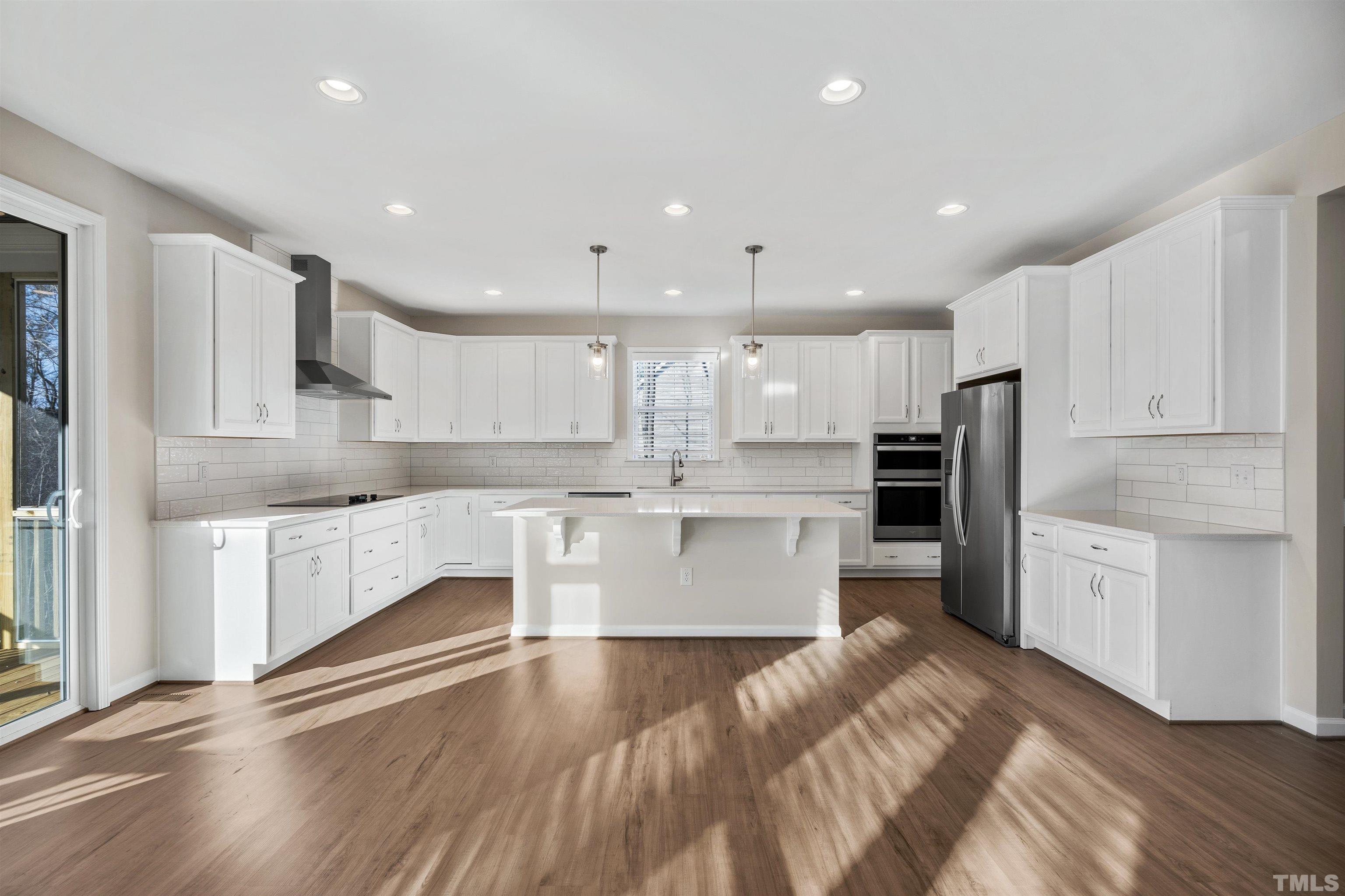 177 Karlov Road Garner, NC 27529 - Photo 38 of 39 a large kitchen with stainless steel appliances and white cabinets