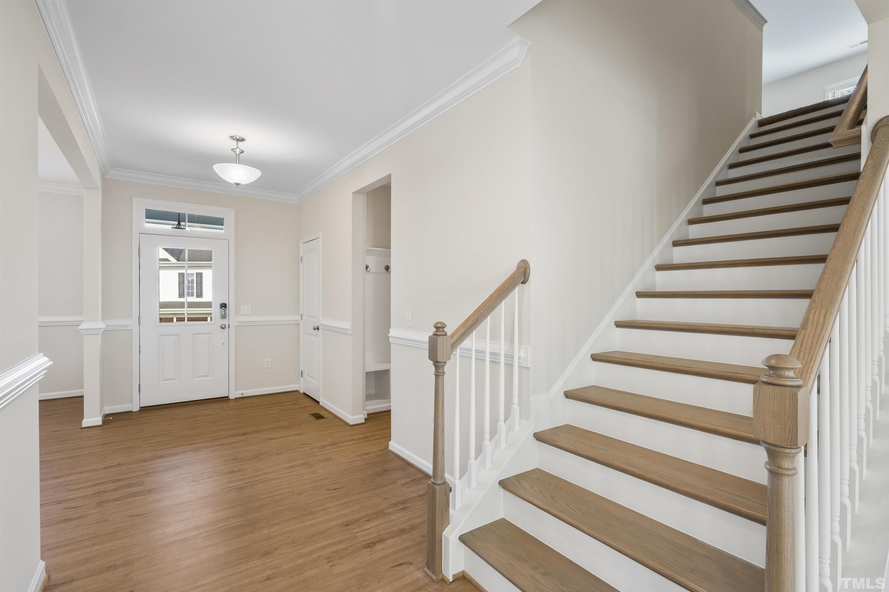 177 Karlov Road Garner, NC 27529 - Photo 7 of 39 a view of entryway with wooden floor and stairs
