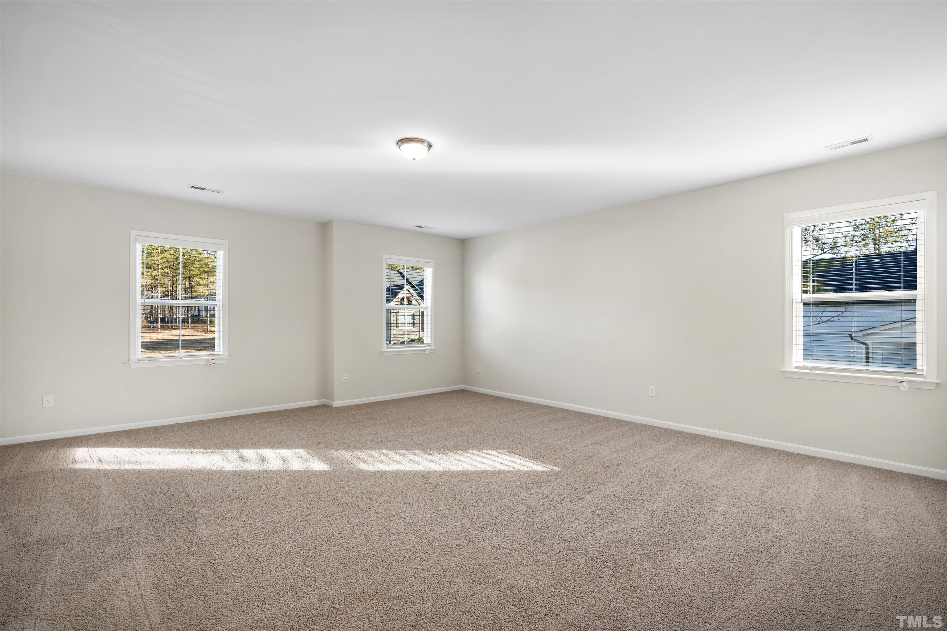 177 Karlov Road Garner, NC 27529 - Photo 8 of 39 an empty room with windows