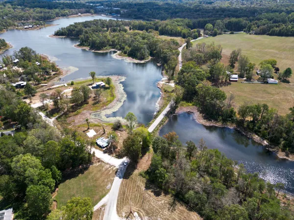 an aerial view of a house with a yard basket ball court and outdoor seating