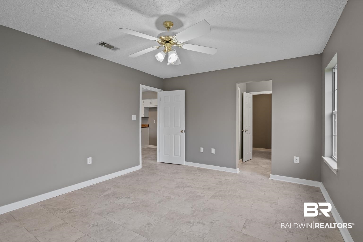 16418 Avent Lane Foley, AL 36535 - Photo 23 of 30 Unfurnished bedroom with a spacious closet, ceiling fan, and a textured ceiling