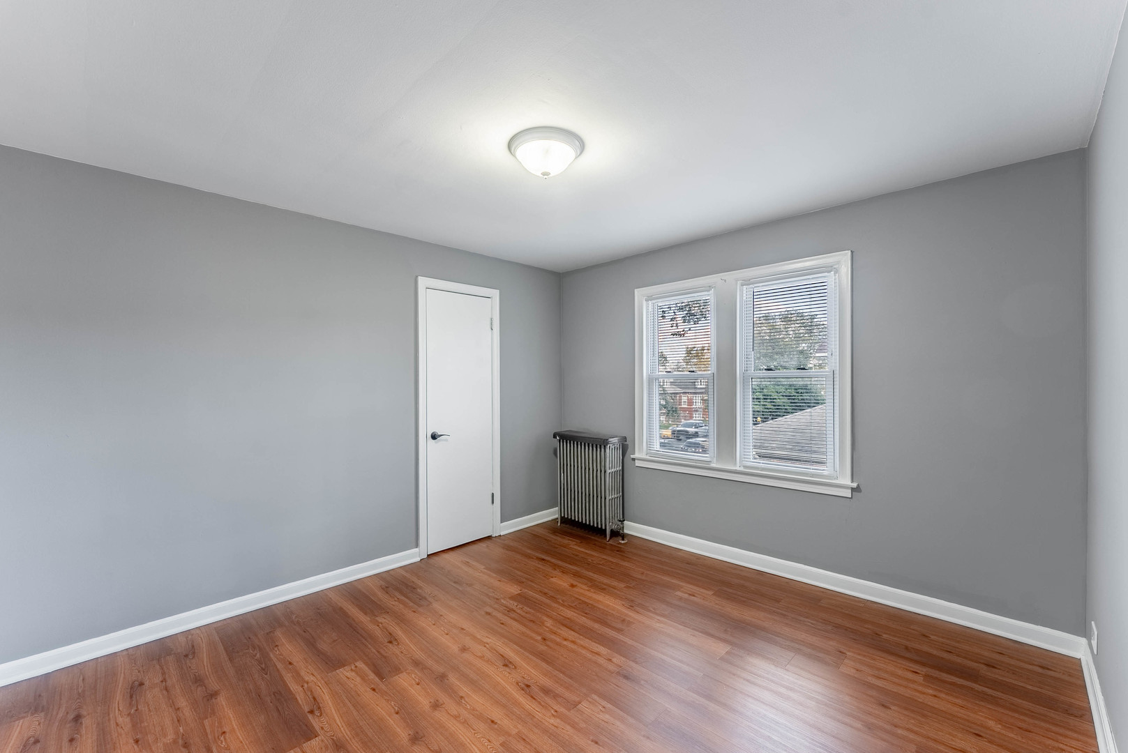 2345 Ridgeland Avenue, Unit 2 Berwyn, IL 60402 - Photo 11 of 18 an empty room with wooden floor and windows