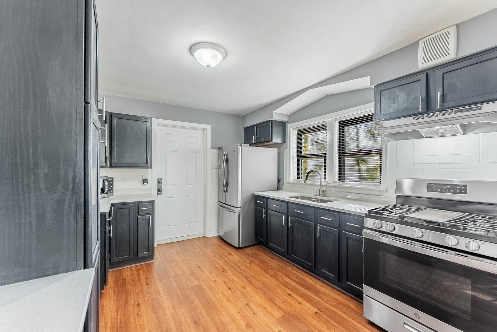 2345 Ridgeland Avenue, Unit 2 Berwyn, IL 60402 - Photo 6 of 18 a kitchen with stainless steel appliances granite countertop a stove and a sink