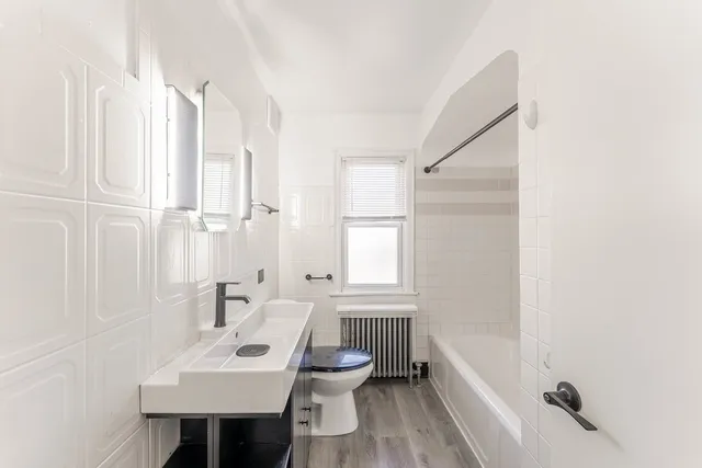 a bathroom with a sink toilet and tub