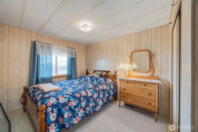 a bedroom with a bed and a dresser