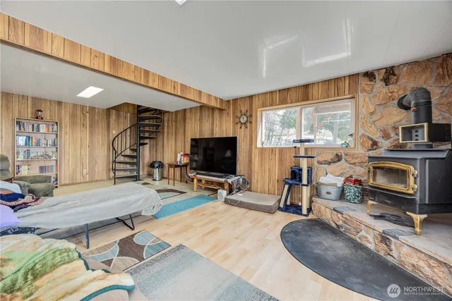 a living room with furniture a flat screen tv and a large window