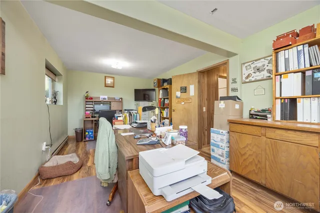 a view of a dining room with furniture a rug and wooden floor