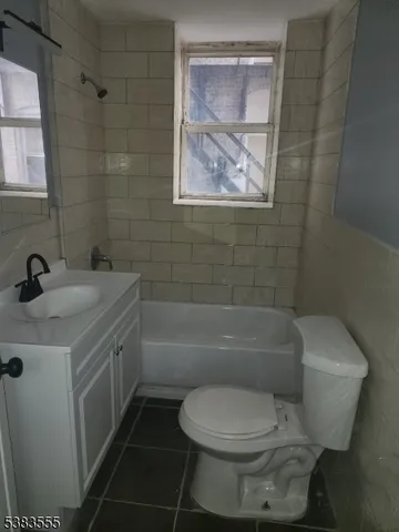 a bathroom with a toilet sink and bathtub