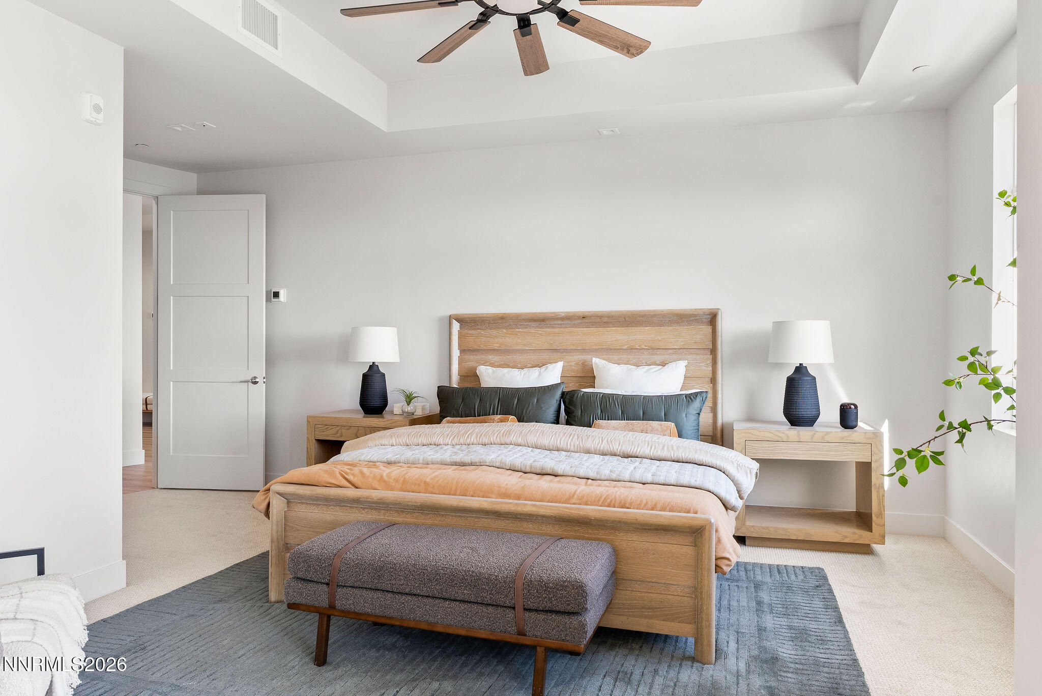 323 Tramway Drive, Unit 107 Stateline, NV 89449 - Photo 11 of 27 a bedroom with a bed a chandelier and a potted plant