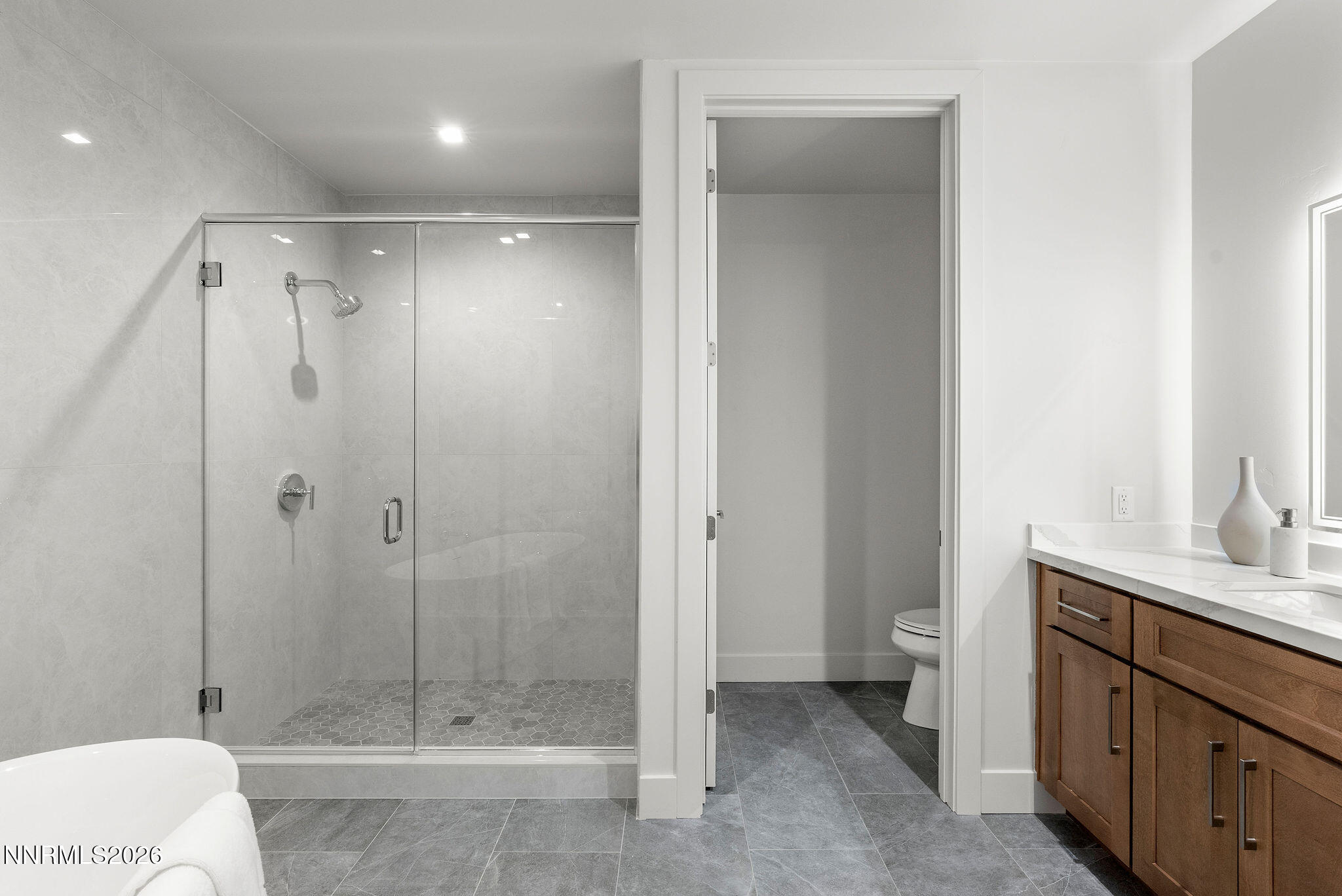 323 Tramway Drive, Unit 107 Stateline, NV 89449 - Photo 14 of 27 a bathroom with a shower a sink and toilet