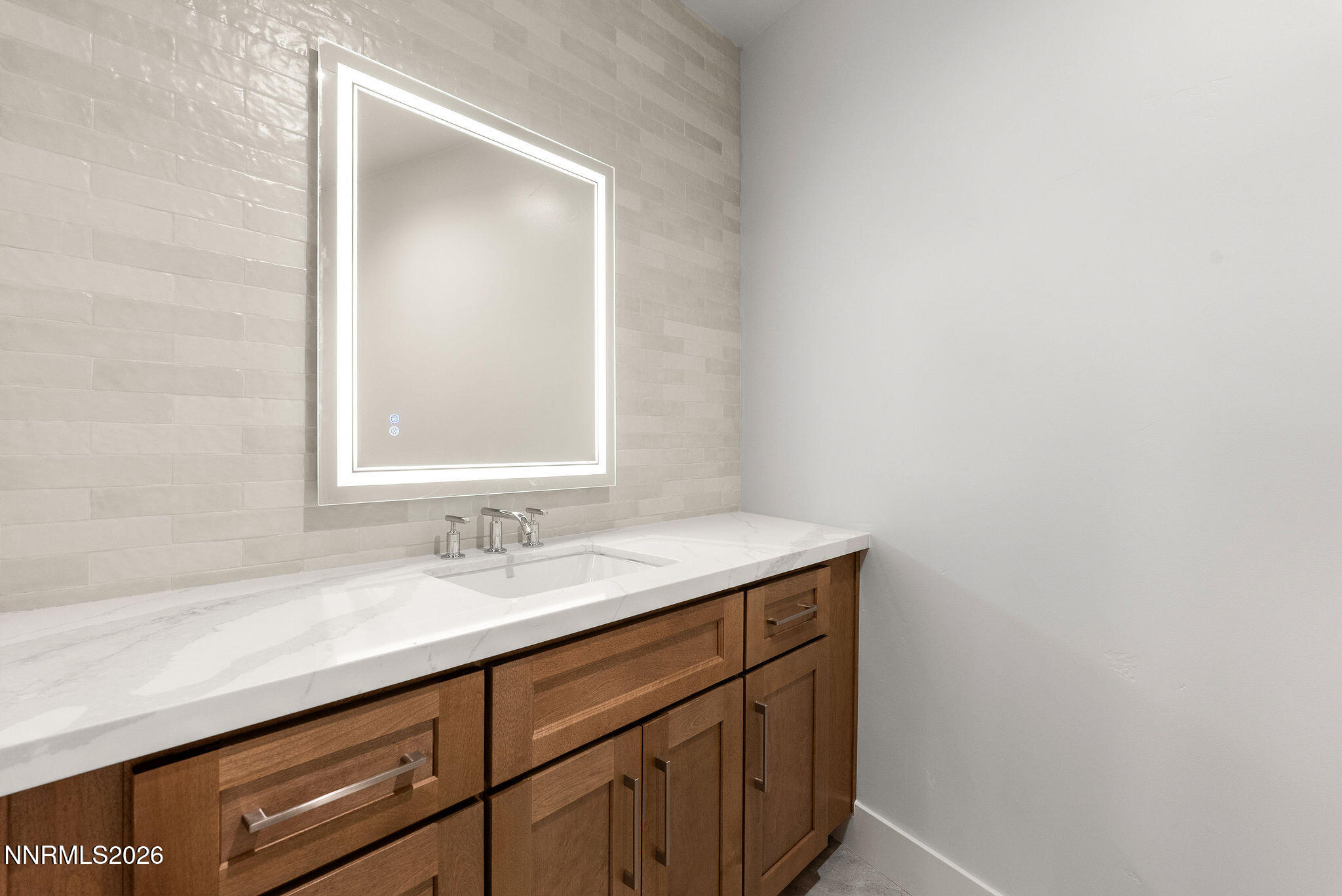 323 Tramway Drive, Unit 107 Stateline, NV 89449 - Photo 23 of 27 a bathroom with a sink and a mirror
