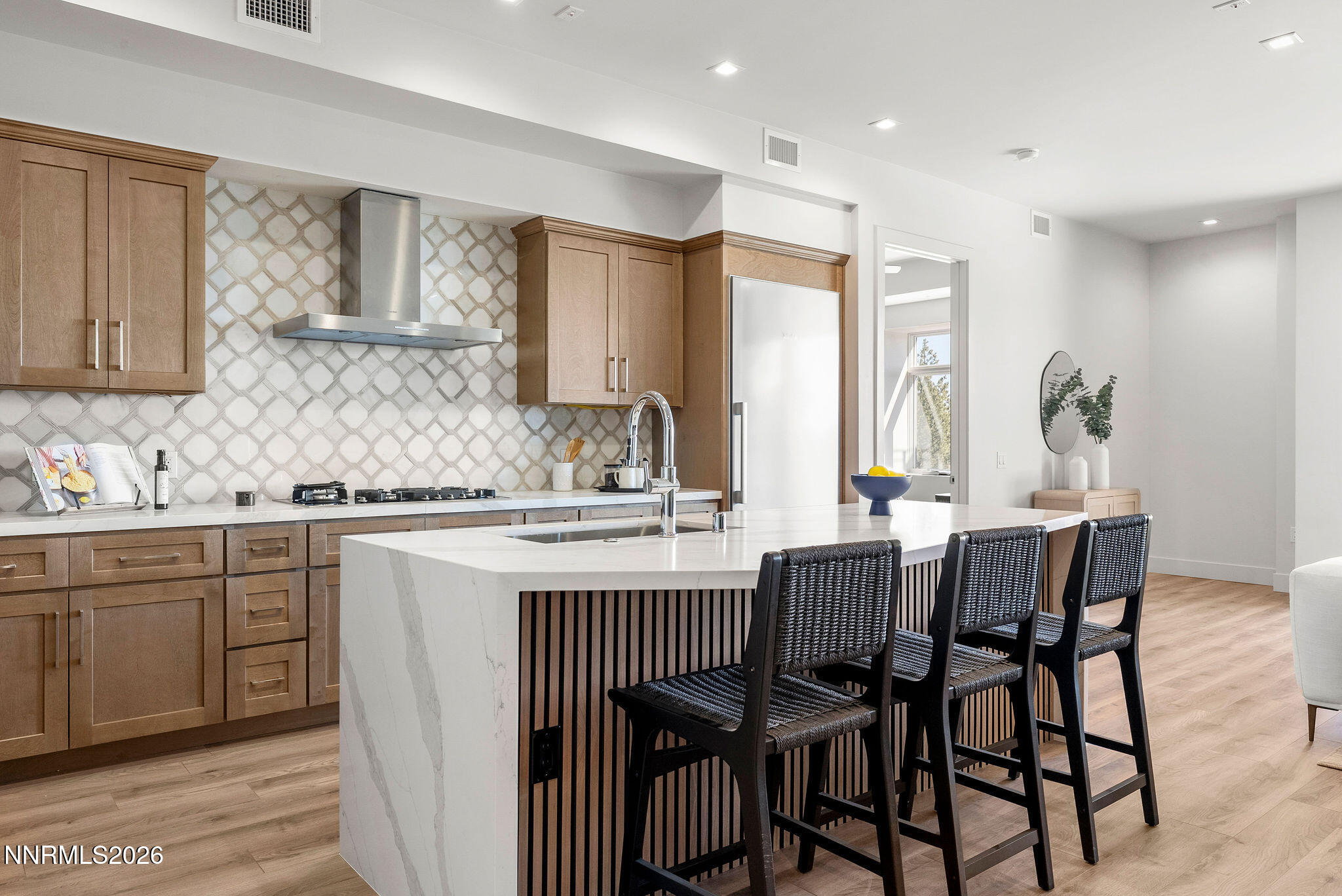 323 Tramway Drive, Unit 107 Stateline, NV 89449 - Photo 3 of 27 a kitchen with a dining table chairs and cabinets