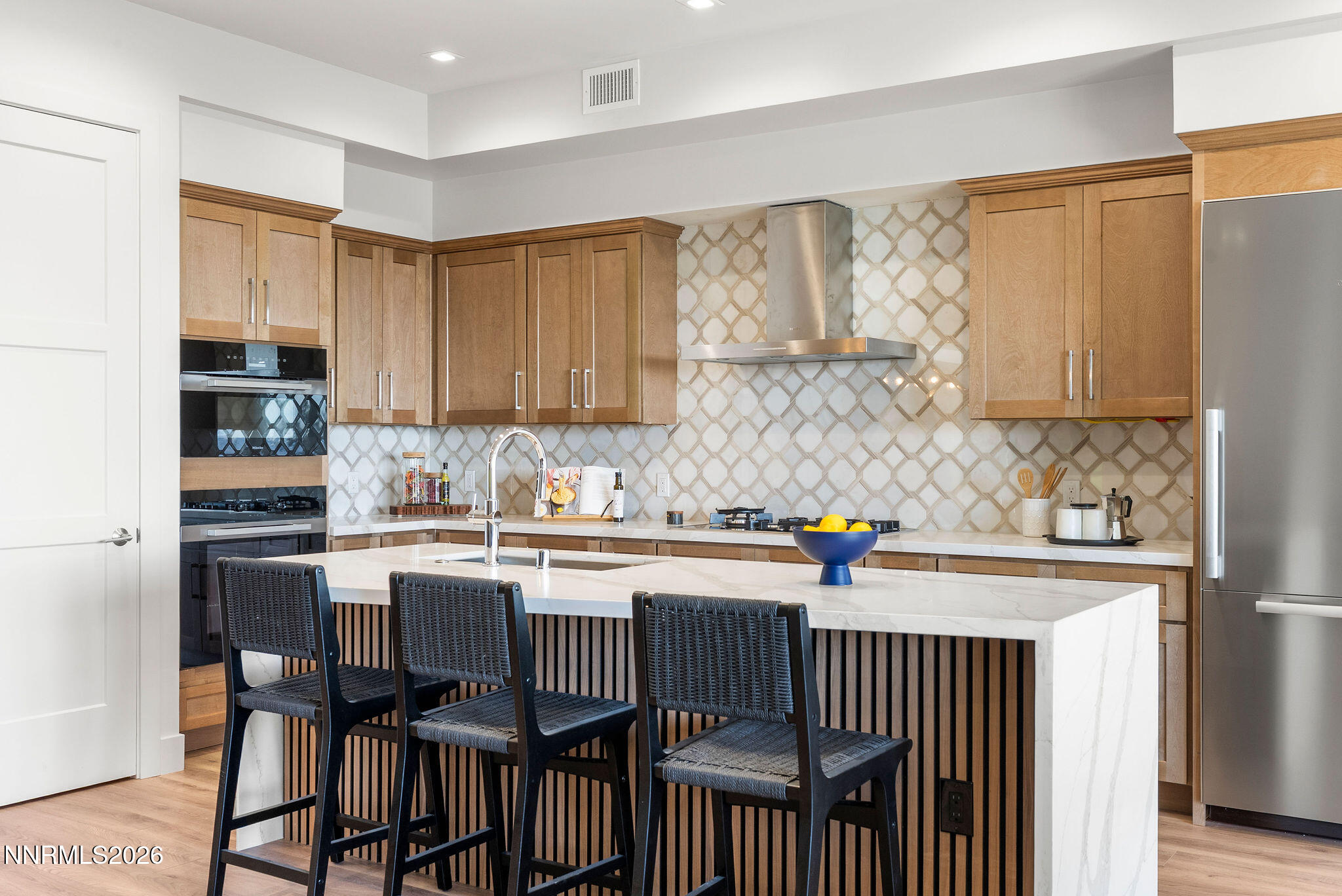 323 Tramway Drive, Unit 107 Stateline, NV 89449 - Photo 4 of 27 a kitchen with stainless steel appliances a sink a stove a table and chairs