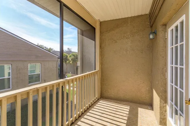 a view of balcony with wooden floor and windows