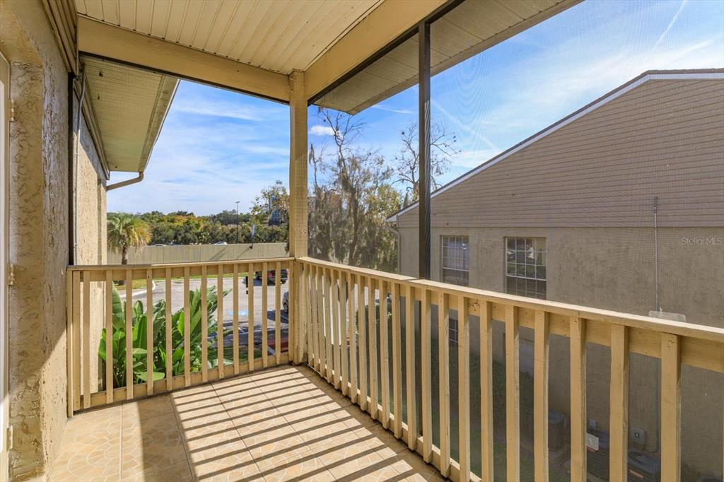 395 Wymore Road, Unit 207 Altamonte Springs, FL 32714 - Photo 13 of 32 a view of a balcony with wooden floor and wooden fence