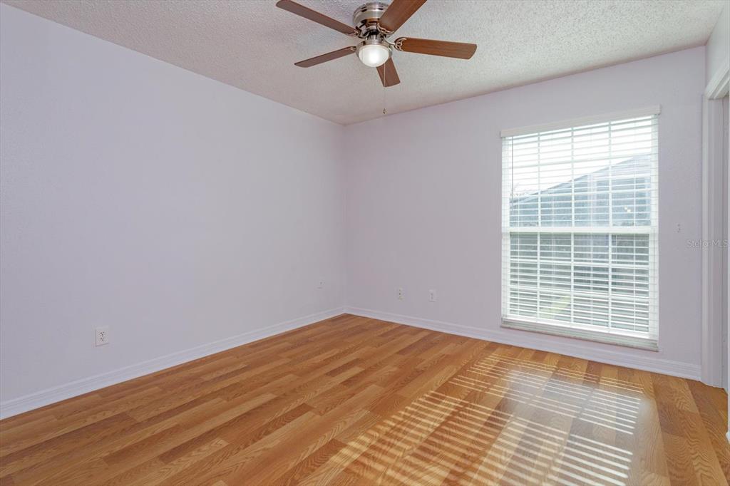395 Wymore Road, Unit 207 Altamonte Springs, FL 32714 - Photo 14 of 32 a view of an empty room with a window and wooden floor