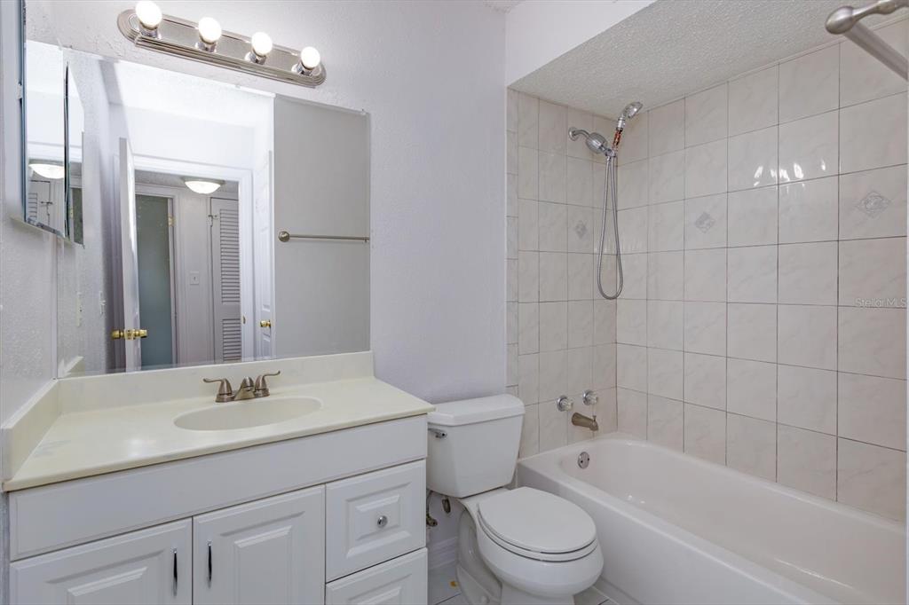 395 Wymore Road, Unit 207 Altamonte Springs, FL 32714 - Photo 19 of 32 a bathroom with a sink a toilet a mirror and shower