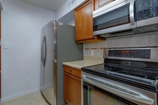a stove top oven sitting inside of a kitchen