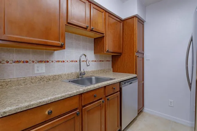 a kitchen with stainless steel appliances granite countertop a sink and cabinets